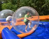 Świetne pomysły na team building: ludzie w dmuchanych kulach na wodzie, śmiech i zabawa gwarantowane!