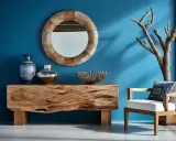 Console en bois brut, miroir rond, vases et fauteuil blanc. Une branche d'arbre sec ajoute une touche naturelle, une belle idée bois flotté.