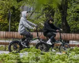 Dwie osoby cieszą się jazdą na rowerach elektrycznych. Dofinansowanie do roweru elektrycznego sprawia, że takie wycieczki są dostępne dla każdego.