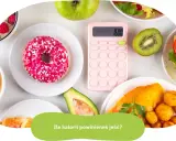Różnorodne jedzenie i kalkulator z napisem "Ile kalorii dziennie?".