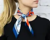 Elegancka gawroszka jak nosić? Wzorzysty apaszek z motywem Londynu zawiązany na szyi, dodaje uroku stylizacji.