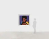 Andy Warhol's iconic portrait of Muhammad Ali, rendered in bold colors, captures the boxer's powerful stance.