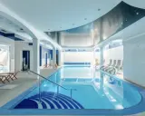 Relaks w spa nad morzem z basenem. Woda w basenie lśni, a sufit ozdobiony jest gwiazdami.