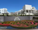 A vibrant floral maze floats in a pool before the modern architecture of the Los Angeles Center for Digital Art.
