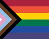 Progress Pride flag with stripes of red, orange, yellow, green, blue, and purple, plus a chevron of white, pink, light blue, brown, and black. This symbolizes inclusivity, suggesting Belize is gay friendly.