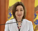 Uśmiechnięta polityk przemawia do mikrofonu. To inspirujący przykład projektu kampanii wyborczej.