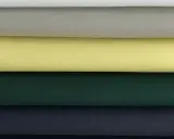 Stacked swatches of poplin fabric in white, light grey, yellow, dark green, and navy blue.