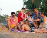 Friends enjoy drinks on the beach, a perfect day at a San Juan gay resort.