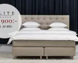 En lyxig dubbelsäng med beige klädsel och en knappad gavel. Elitsängar för en drömlik sömn.