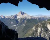 Vista mozzafiato dal **Monte Piana**, con valli profonde, foreste rigogliose e cime maestose sotto un cielo azzurro.