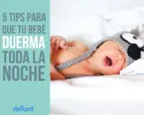 Un bebé con gorro de búho, con la boca abierta, en la cama. 5 consejos para que tu bebé duerma toda la noche.