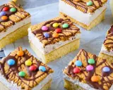 Bunte Geburtstagskuchen für Kinder, dekoriert mit Keksen, Schokolade und bunten Smarties.