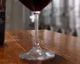 Bottiglie di Vino Nobile di Montepulciano e un calice di vino rosso, pronti per una degustazione vini toscana.