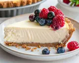 Tranche de cheesecake sans cuisson garnie de fruits rouges frais.