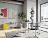 Nowoczesne wnętrze w stylu bauhaus z okrągłym stołem, krzesłami z chromowanej rury i abstrakcyjnymi obrazami na ścianie.