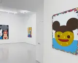 A gallery showcases vibrant paintings by Eli Klein. One features a cartoon rabbit and bikini-clad torso with smoke, another a colorful abstract, and a large piece with a yellow, Mickey Mouse-like face.