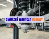 Widok na zawieszenie samochodu z widocznym sworzniem wahacza. Wymiana sworznia wahacza może być konieczna, gdy pojawią się niepokojące objawy.