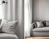 En grå, nopprig soffa med mjuka kuddar framför ett ljust draperi. En inbjudande sittplats för avkoppling.