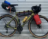 Gravelbike mit Packtaschen für Bikepacking. Das Zelt ist im Satteltaschen-Setup verstaut, bereit für das nächste Abenteuer.