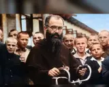 Święty Maksymilian Kolbe w otoczeniu chłopców, z charakterystyczną brodą i okularami, trzymający fragment roweru.