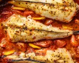 Colas de rape al horno, tiernas y jugosas, nadando en una salsa de tomate y limón. Un plato delicioso y fácil de preparar.