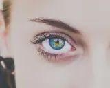 Ojo con iris azul y amarillo, pestañas largas y cejas definidas tras un laminado de cejas.
