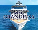 La MSC Grandiosa solca il mare blu, un gigante bianco con ponti che promettono avventure.