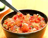 En skål med färsk pico de gallo, en klassisk mexikansk salsa med hackade tomater, lök och koriander. Perfekt till tacos!