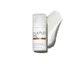 Olaplex N°6 Bond Smoother Flasche mit weißer Creme-Textur daneben.