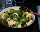 En skål med ugnsrostad blomkål och broccoli, toppad med färska örter. Perfekt som tillbehör till middagen.