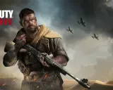 Żołnierz z karabinem w Call of Duty Vanguard, na tle pustynnego krajobrazu i samolotów.