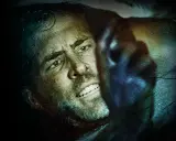 Ryan Reynolds i en intensiv scen från en av hans filmer. Ansiktet är svettigt och han ser ut att vara i fara.
