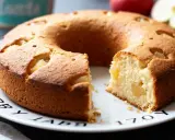 Gâteau rond aux pommes, idéal pour bébé, sans sucre ajouté. Une tranche est coupée, révélant la texture moelleuse et les morceaux de pomme.