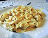Pyszne tagliatelle z kurczakiem w kremowym sosie, podane na białym talerzu.