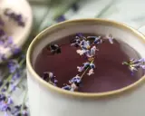 Aromatic herbata z lawendy, choć relaksująca, ma swoje przeciwwskazania. Napar w filiżance z kwiatami lawendy.
