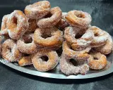 Montón de buñuelos de cuaresma espolvoreados con azúcar, listos para disfrutar.
