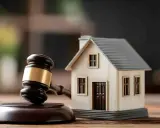 Marteau de juge et maison miniature, symbolisant une décision de justice immobilière. Respecter le loi scrivener délai est crucial.