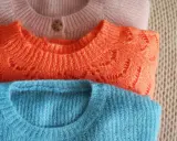 Gestapelte Pullover in Rosa, Orange und Blau. Die feine Wolle lädt zum Waschen ein, damit sie wieder flauschig wird.