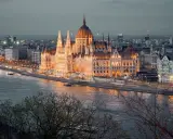 Wspaniały Parlament w Budapeszcie o zmierzchu, oświetlony ciepłym blaskiem. To miejsce, co warto zobaczyć w Budapeszcie, zachwyca nad Dunajem.