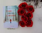 Copertina del libro "Fiori sopra l'inferno" di Ilaria Tuti, con rose rosse su sfondo innevato.