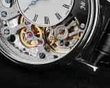 Dettaglio di un orologio scheletrato con ingranaggi dorati e rubini che riducono l'attrito, mostrando a cosa servono i rubini negli orologi.