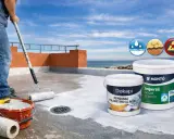 Aplicación de membrana para impermeabilización de terrazas. Rodillo y cubos de pintura listos para proteger tu hogar del agua.