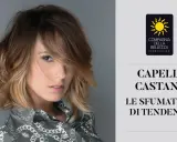 Modella con capelli castani sfumati, un esempio di tabella colori capelli castani con tonalità di tendenza.
