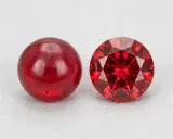 Due pietre rosse brillanti, una liscia e sferica, l'altra sfaccettata e scintillante: il minerale del rubino in due forme.