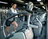 Mann macht ein Stairmaster Workout im Fitnessstudio.