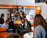 A group of young people pose for a photo, holding a sign that says "CASA LABA".