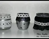 Three decorated glass jars with lace and beads.