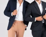 Two men in navy blazers and white shirts. One wears tan pants, the other dark pants. Is semi formal and cocktail attire the same?