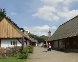 Spacer po największym skansenie w Polsce. Drewniane chaty, kościółek i zielone wzgórza tworzą malowniczy krajobraz.
