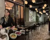 Kobieta z kieliszkiem wina w jednej z klimatycznych restauracji na krakowskim Starym Mieście. Wnętrze lokalu z nowoczesnym designem.
